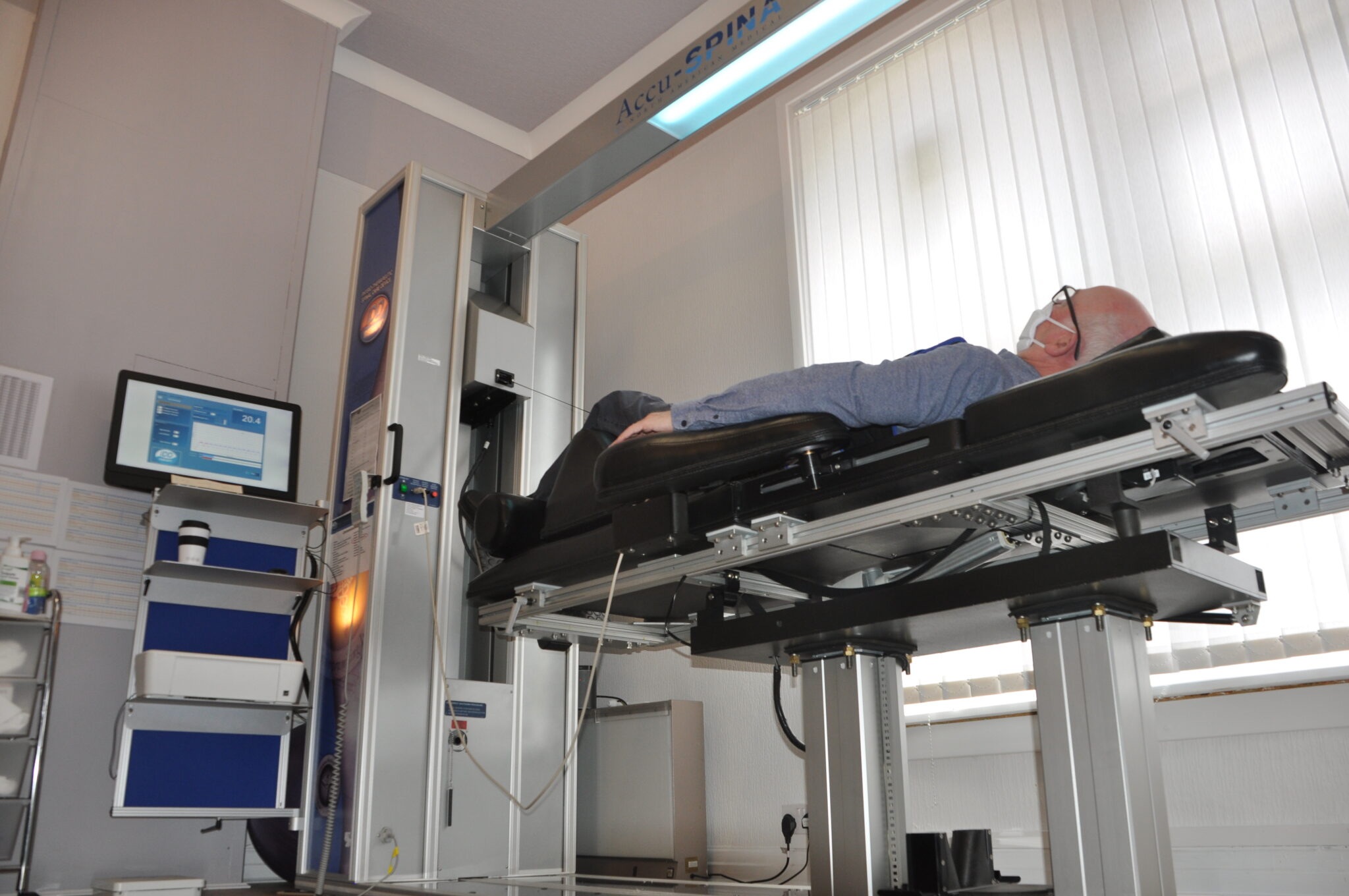 IDD Therapy at Bolton Spinal Health. The image shows a man on the IDD Therapy machine at Bolton Spinal Health.